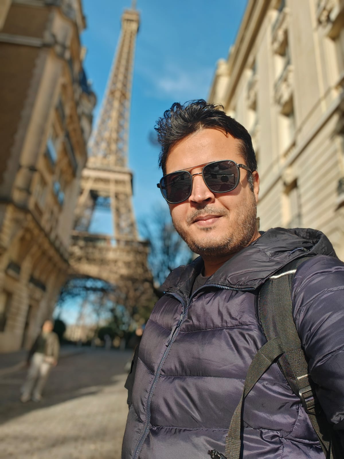 Traveller taking a selfie beside the Eiffel Tower in Paris